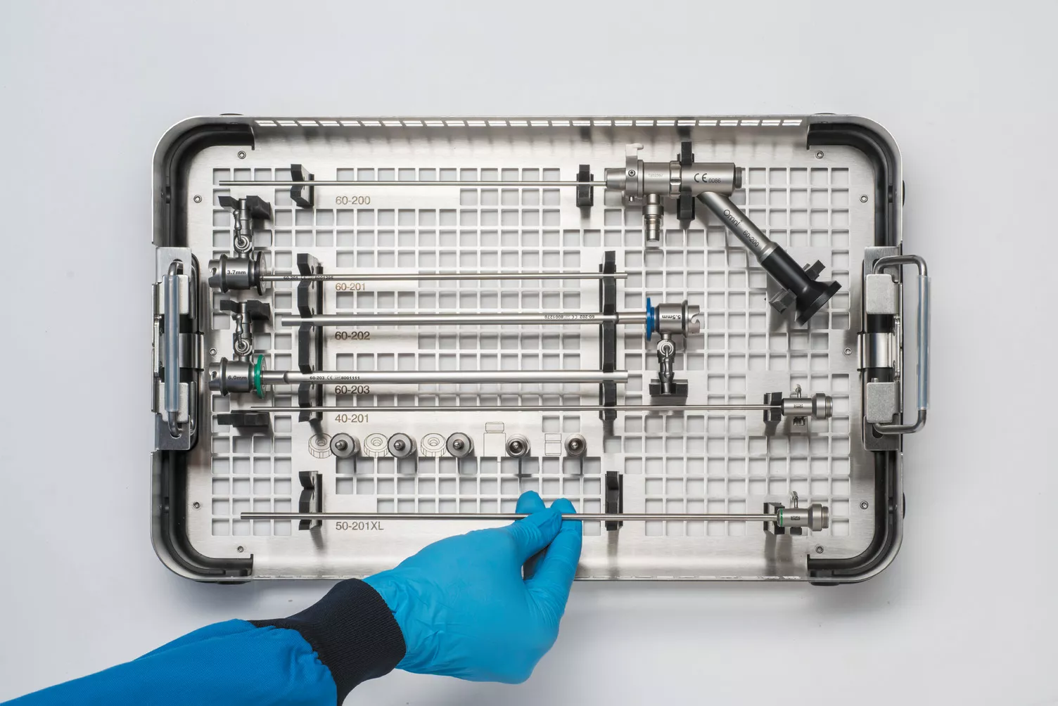 Mano con guanto che lavora su un cestello appoggiato su un ripiano.